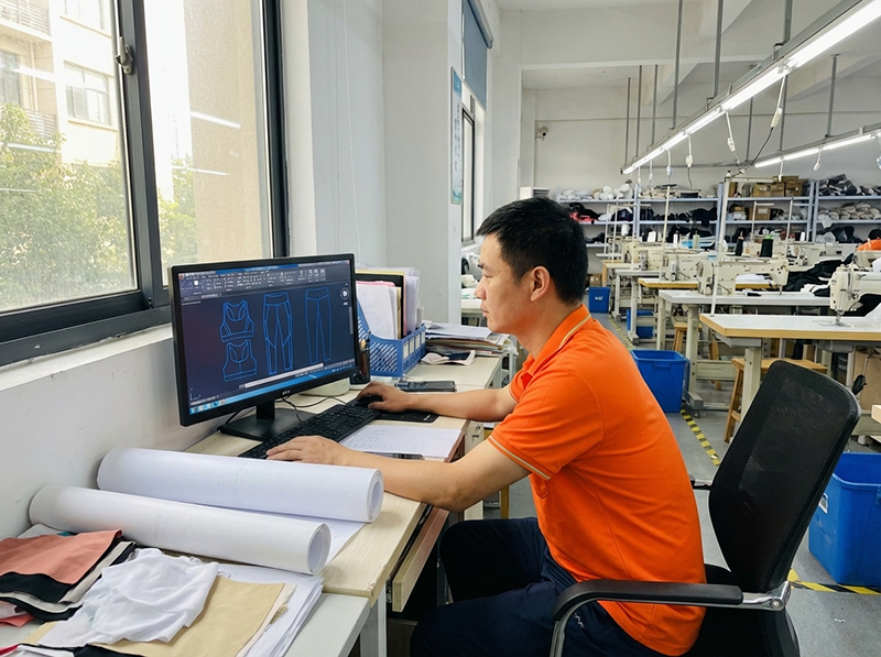 professional activewear pattern making process using cad software asian garment factory designer creating technical patterns for yoga pants leggings and sports bras manufacturing